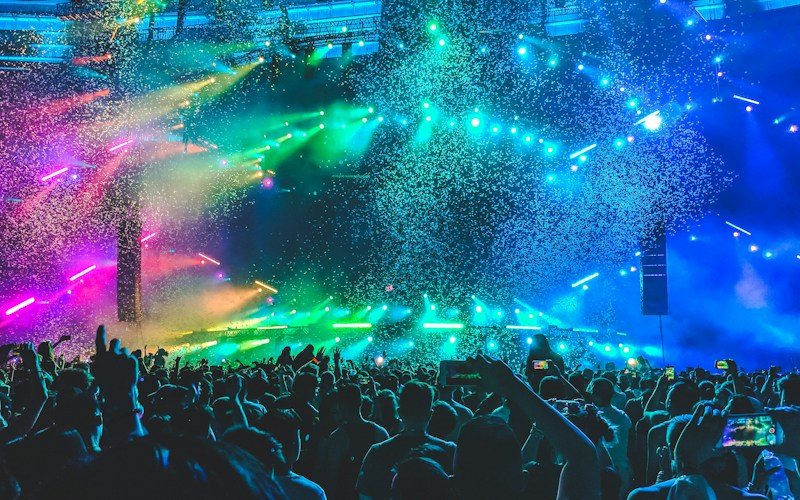 Concert crowd bathed in dramatic stage lighting