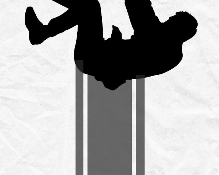Silhouette of a person falling down an escalator